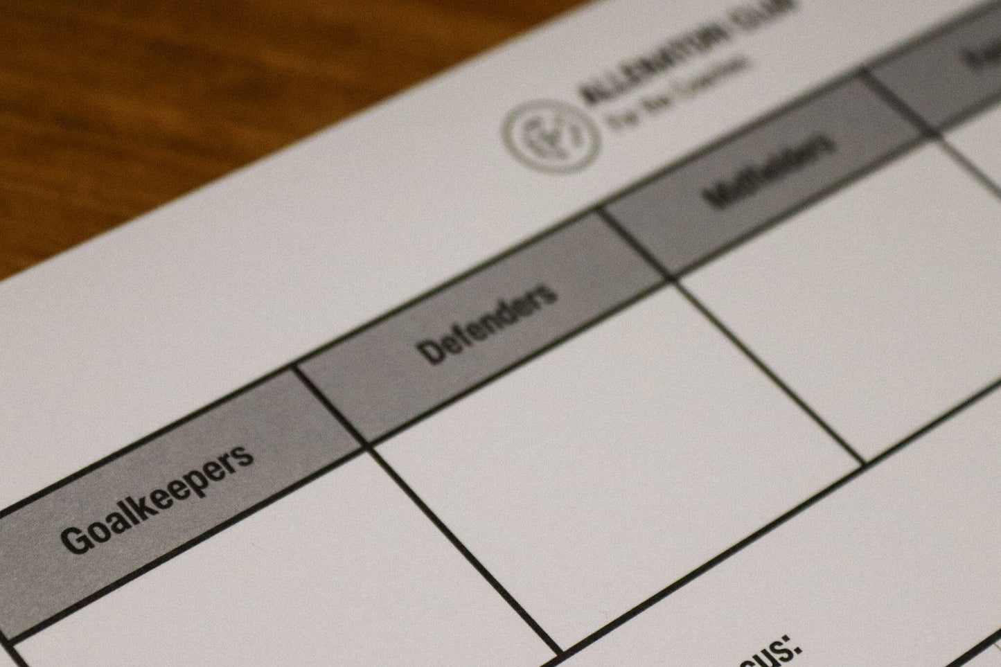 Close-up of an Allenatori Club football coaching sheet showing player position columns including Goalkeepers, Defenders, and Midfielders.