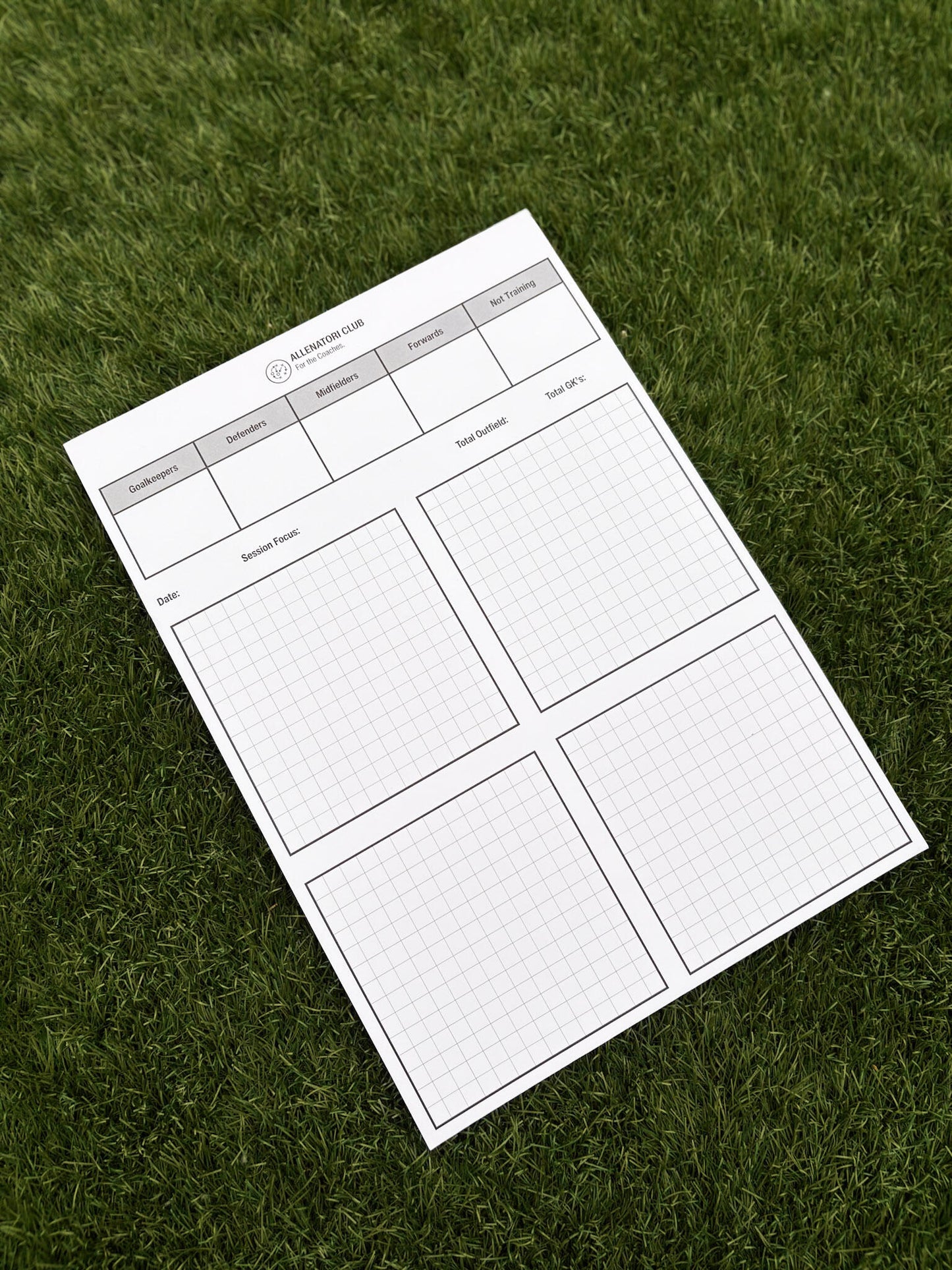 Allenatori Club match day planner sheet on grass with player position columns and session planning grid sections.