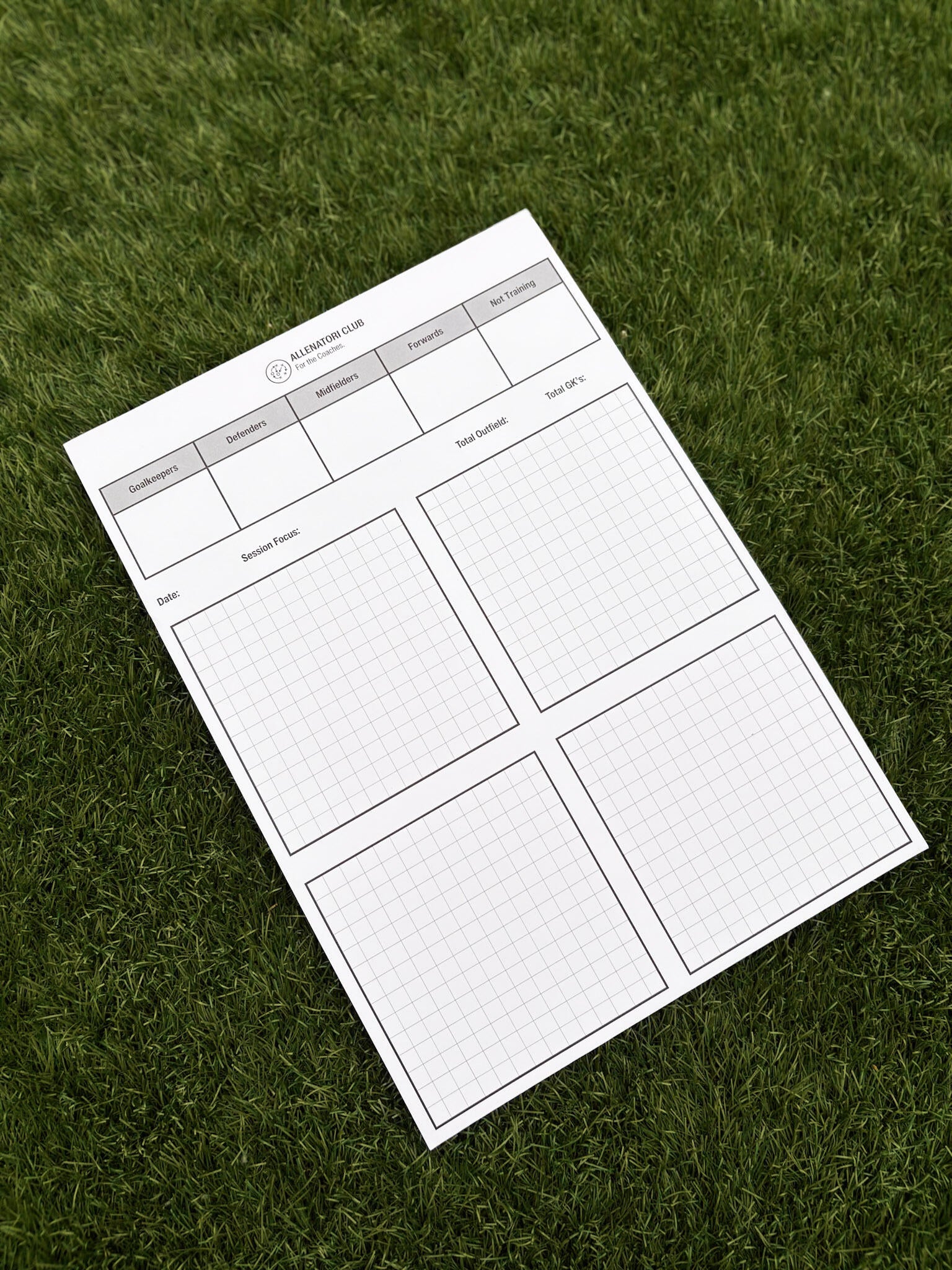 Allenatori Club match day planner sheet on grass with player position columns and session planning grid sections.