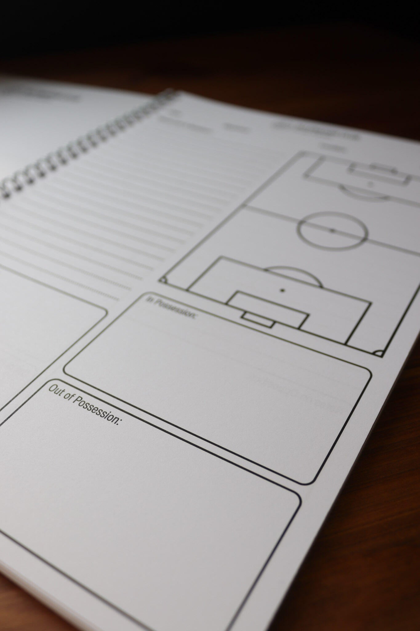 Open Allenatori Club coaching notebook showing a football pitch diagram with In Possession and Out of Possession note sections.